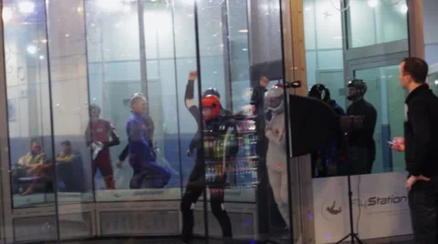 Group of people dance inside fly station. Simulator of skydiving. Contest Stock Footage 67558183