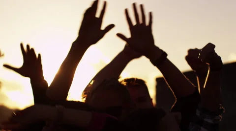 Group of People Dancing and Raising Hands Outdoors in Sunlight. Slow Motion Shot Stock Footage