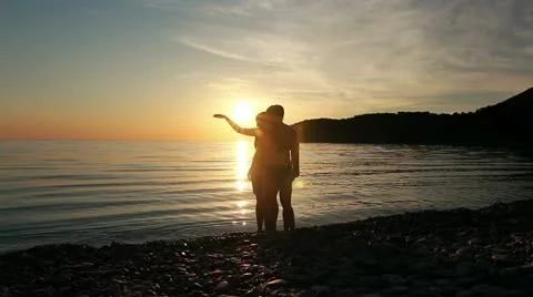 Group of people dancing on the beach at sunset.  Stock Footage 21931762