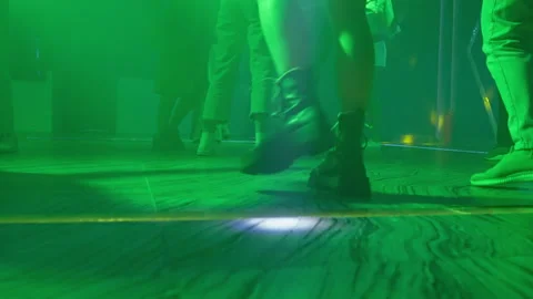 Group of people dancing at a disco in a floor level view Stock Footage 203950694