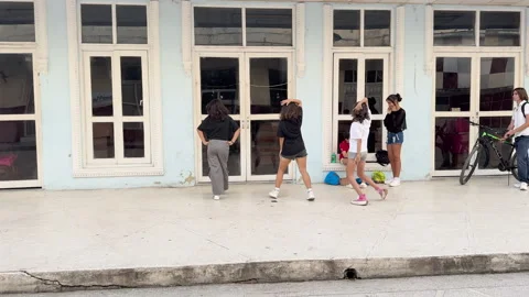 Group of people dancing outdoors in front of a building Stock Footage 313274468