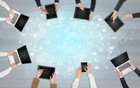 Group of people with devices in hands working on laptops and tablets Stock Photos