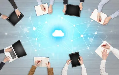 Group of people with devices in hands working on laptops and tablets Stock Photos