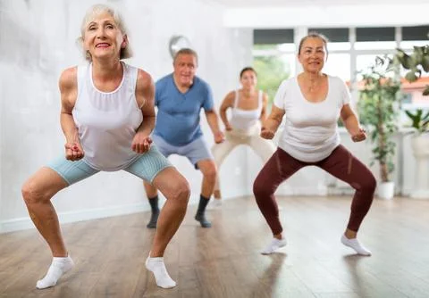 Group of people of different ages dancing in studio Stock Photos