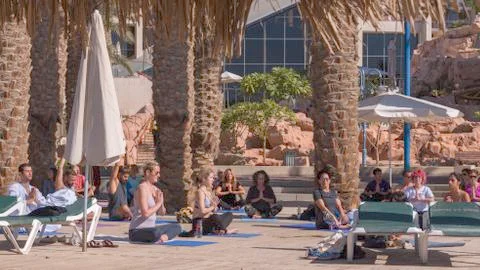 A group of people of different ages, from different countries doing yoga Stock Photos