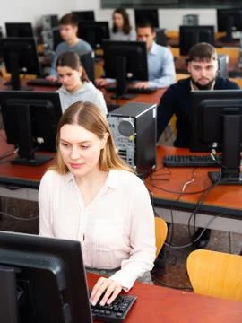 Group of people of different ages learning to use computers in classroom 스톡 사진