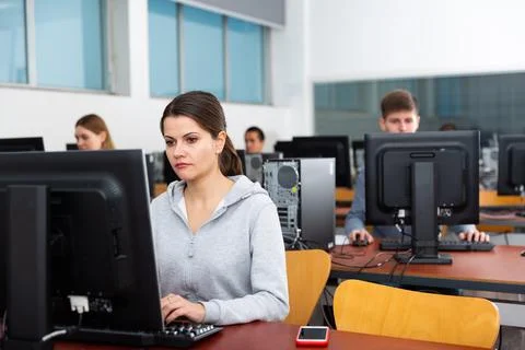 Group of people of different ages learning to use computers in classroom 写真素材