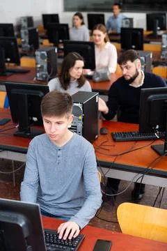 Group of people of different ages learning to use computers in classroom 스톡 사진