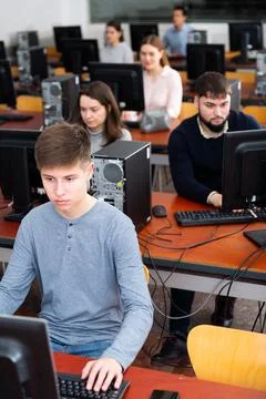 Group of people of different ages learning to use computers in classroom 스톡 사진