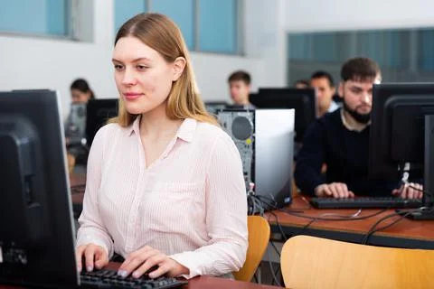 Group of people of different ages learning to use computers in classroom Stock-Fotos