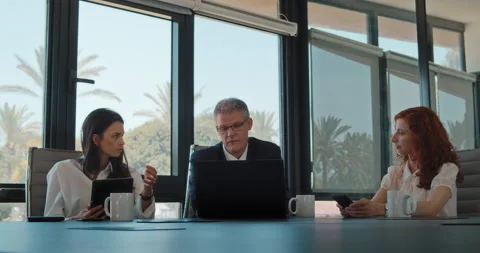 Group of people discuss a project using a computer at workplace. Stock Footage 139918678