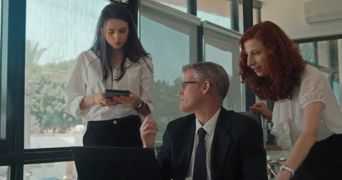 Group of people discuss a project using a computer at workplace. Stock Footage 139922207