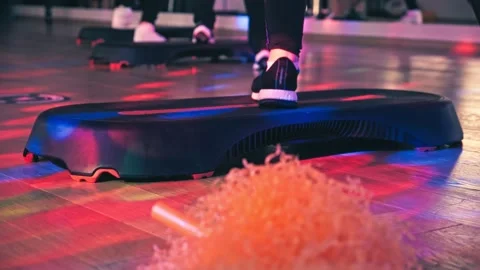 Group of people do aerobics on a step platform to music in the gym Stock Footage 177988177