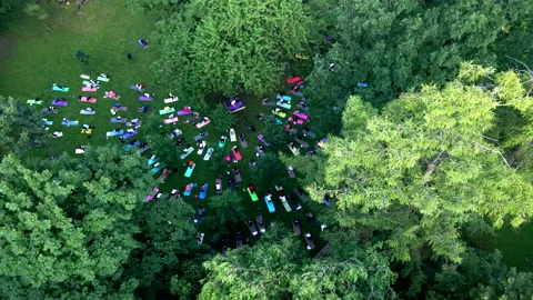 Group of people doing exercise at city public park Stock Footage 159487164