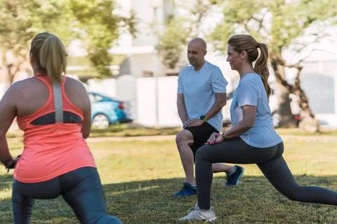 Group of people doing front splits outdoors Stock Photos