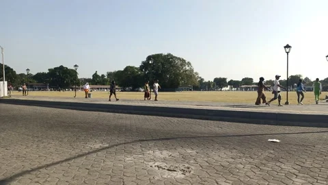 Group of people doing a healthy walk around the field Stock Footage 313169013