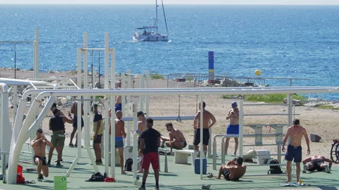 Group of People doing Physical Exercises at the Beach in Barcelona A Boat at sea Video stock 135780662