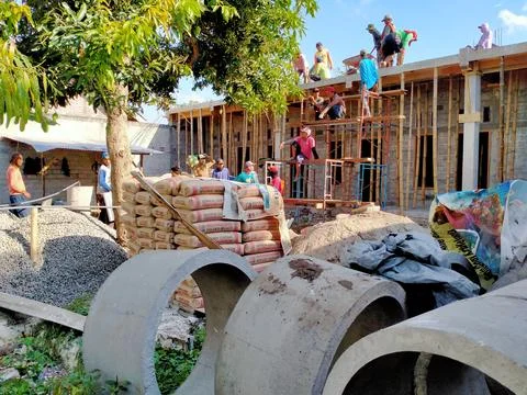 A group of people doing the process of building a house Stock Photos