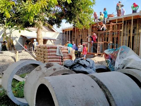 A group of people doing the process of building a house Stock Photos