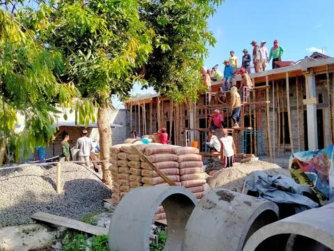 A group of people doing the process of building a house Stock Photos