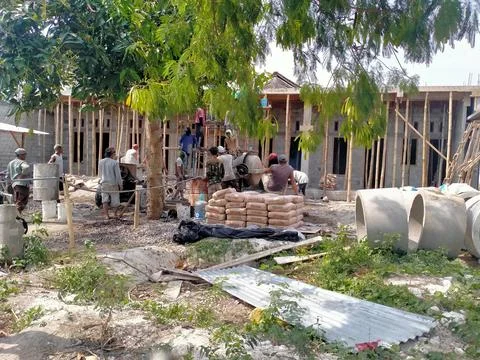 A group of people doing the process of building a house Stock Photos