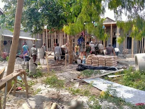 A group of people doing the process of building a house Stock Photos