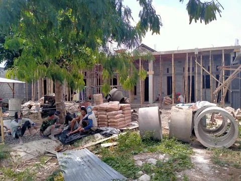 A group of people doing the process of building a house Stock Photos