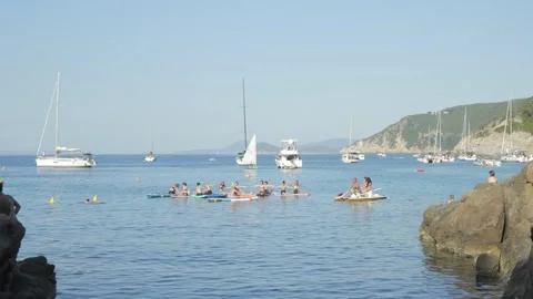 Group of people doing SUP yoga on sea, Elba island, June 1, 2026, Italy Stock Footage 336315152