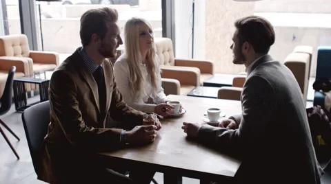 Group of people drinking coffee and chatting at a cafe. Stock Footage 61157749