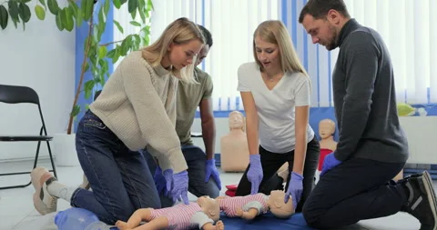 Group of people during the first aid training with instructor showing on manikin Stock Footage 163977941