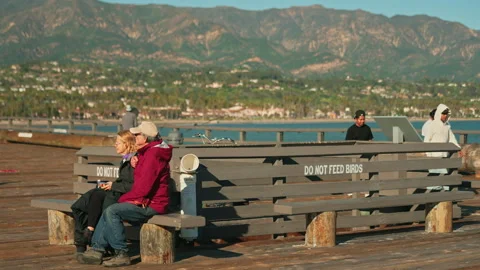 Group of people enjoying the views of the Pacific Ocean at Santa Barbra pier Stock Footage 341666810