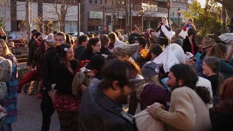 Group of people enjoying while fighting with pillows at pillow fight festival Stock Footage 103421931