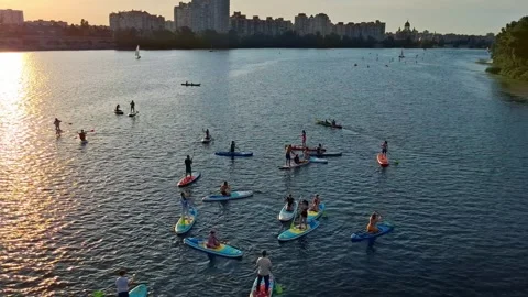 Group of people floating on SUP boards on Dnieper River in Kyiv city, Ukraine Stock Footage 315439173