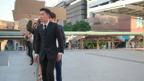 Group of people follow the leader who look like confuse and make them wrong way Stock Footage 143506669