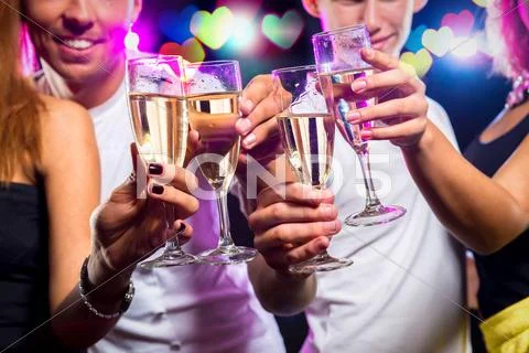 Group of people with glasses of sparkling champagne over abstract background Stock Photos