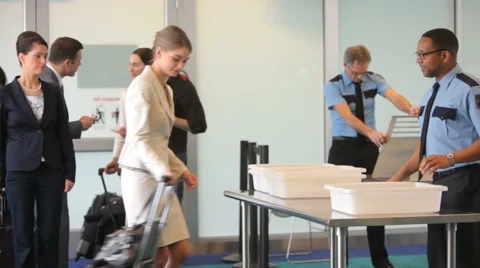 Group of people go through security at airport Stock-Footage 61673354