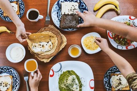 Group of people having breakfast Stock Photos