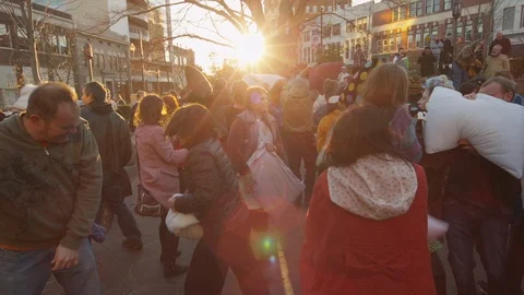 Group of people having fun during the pillow fight festival on a sunny day Stock Footage 103421811