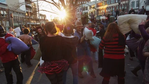 Group of people having fun during the pillow fight festival on a sunny day Stock Footage 103421833