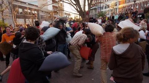 Group of people having fun during the pillow fight festival on a sunny day Stock Footage 103421959