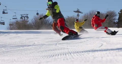 Group of people having fun snowboarding downhill on a ski slope during winter Stock Footage 255239649