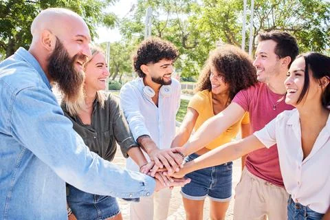 Group of people having fun together. Multiracial smiling friends stacking hands Stock Photos