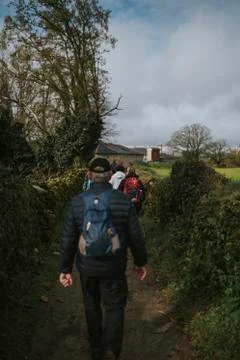Group of people hiking in a row. Stock Photos