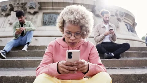 Group of people ignoring each other using phone with serious face. Latina woman Stock Footage 236577224