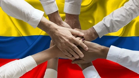 Group of people joining hands over waving colombian flag animation loop Stock Footage 121932295
