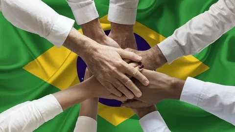 Group of people joining hands over waving brazilian flag animation loop Stock Footage 122384553