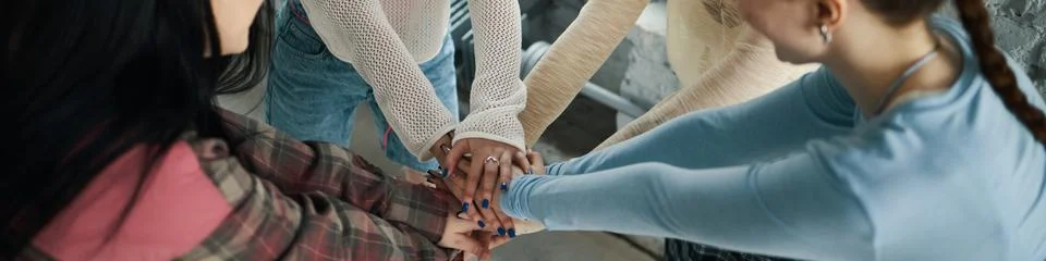Group of People Joining Hands in Unity Gesture Stock Photos