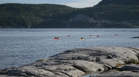 Group of people kayaking across a river Stock Footage 63868727