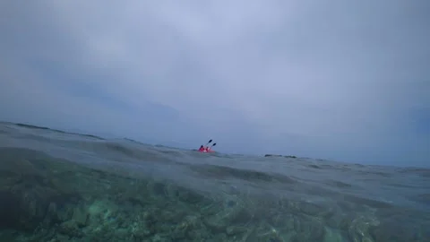 A group of people kayaking through clear water Video stock 295384713