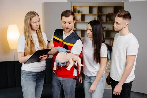 Group of people learning how to make first aid with dummy child during the .. Stock Photos